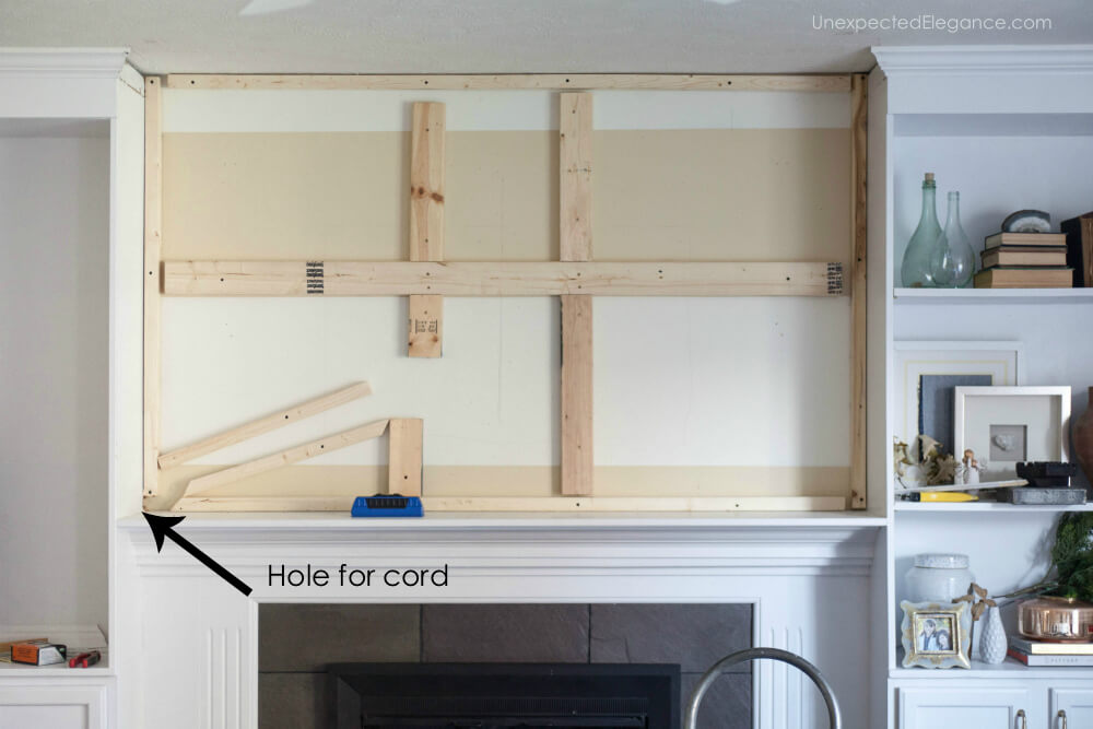 Check out this tutorial for hiding the TV cords above the fireplace.